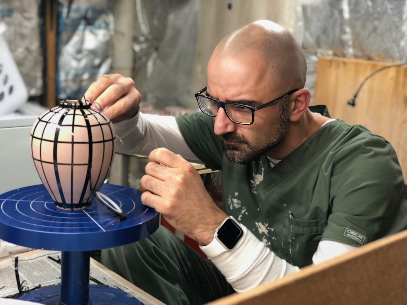 Peter Kosa painting a geometric pattern onto a thrown vessel
